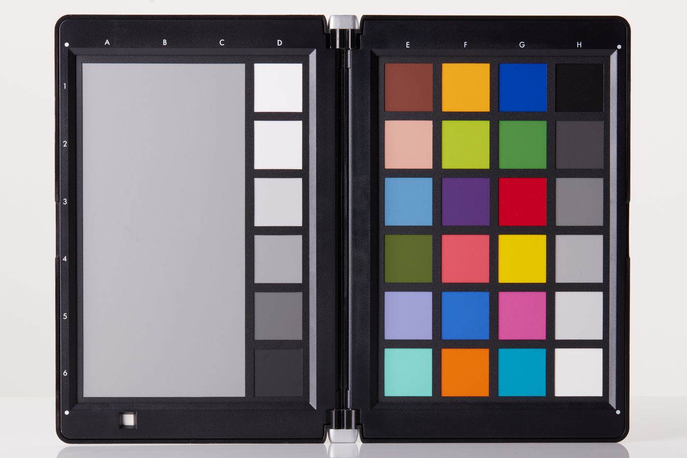 An open photographic colour calibration target: a grid of twenty-four reference patches whose bottom row is a neutral greyscale