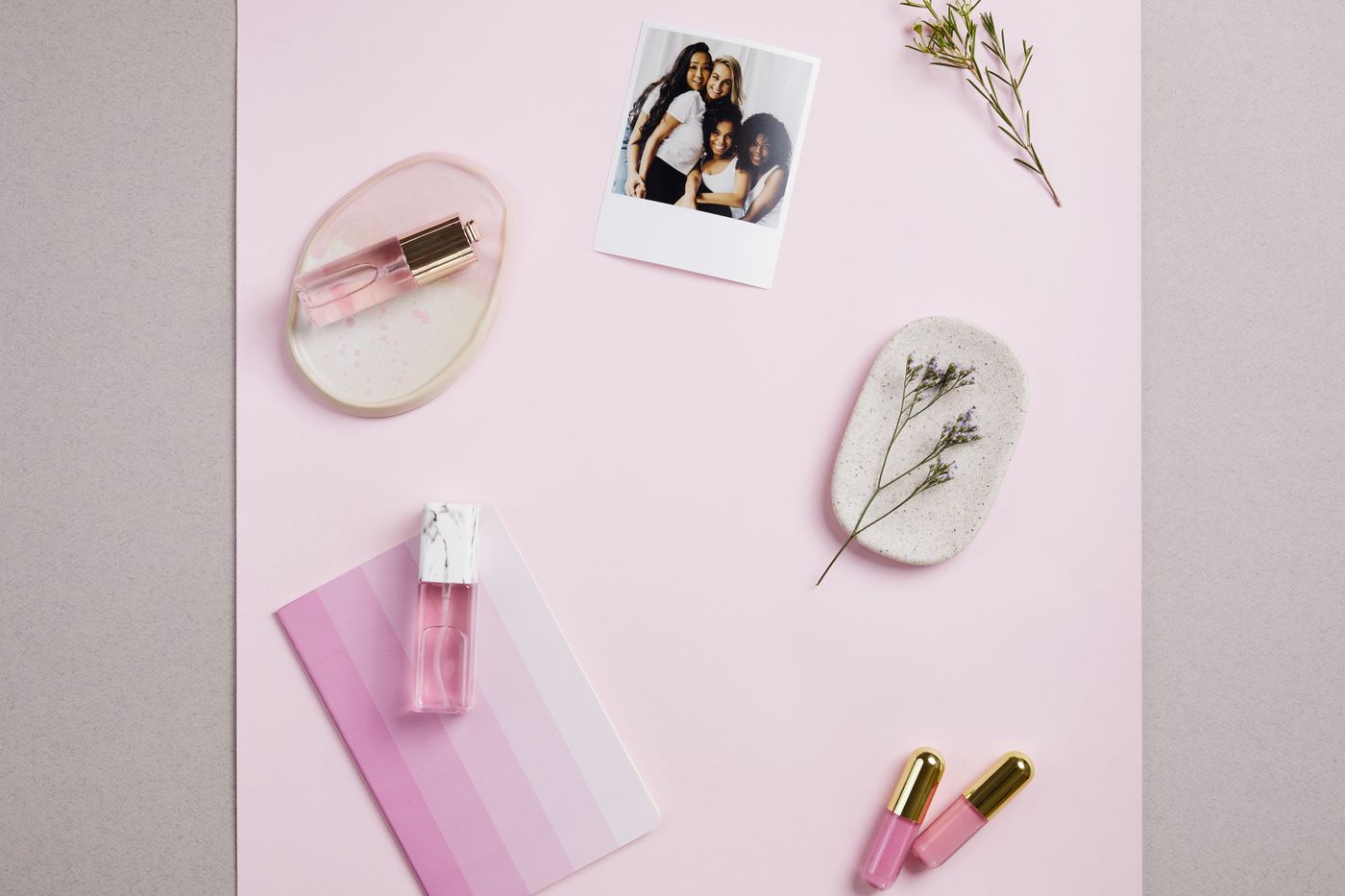 A cosmetics bottle staged in a distinctive branded scene with colored backdrop and props that a competitor could not reuse unnoticed