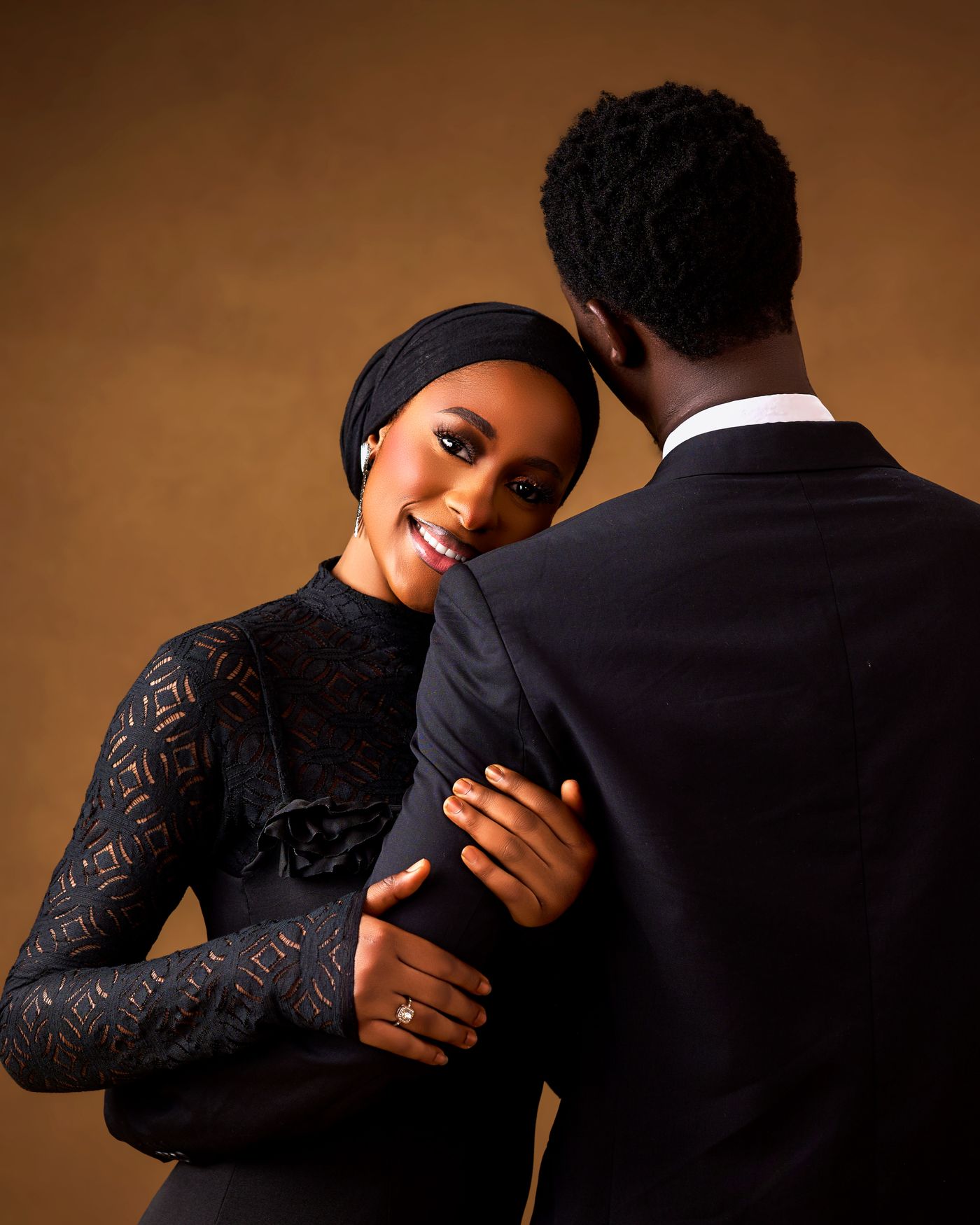 An engaged couple cut out from a cluttered snapshot and placed on a soft, elegant neutral backdrop for a save the date card
