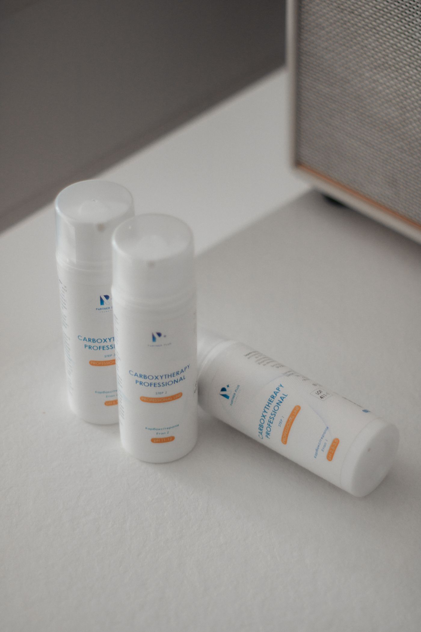 Three unbranded cosmetic bottles standing upright and evenly lit on a plain white surface with no text, borders or props in the frame.