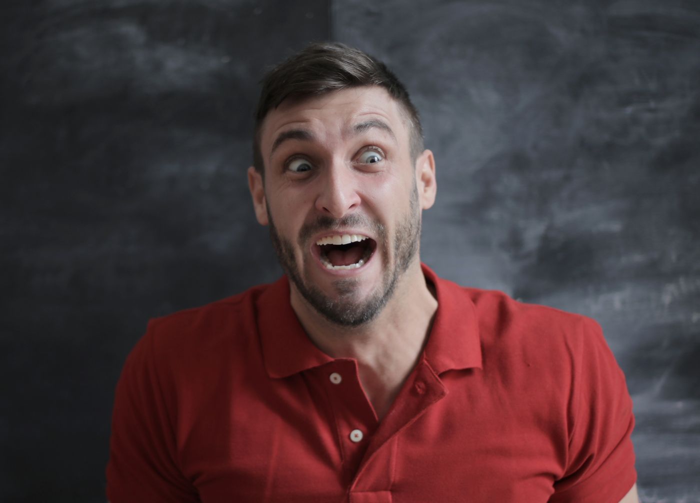 Streamer making an exaggerated shocked expression into the camera at a ring-lit desk setup