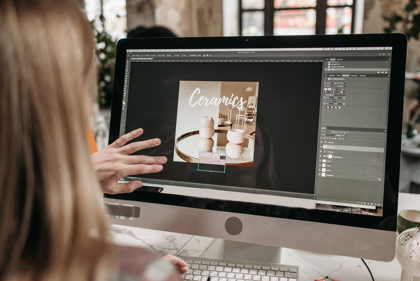A single sneaker product cutout being repositioned across three banner layouts of different shapes on a designer's screen