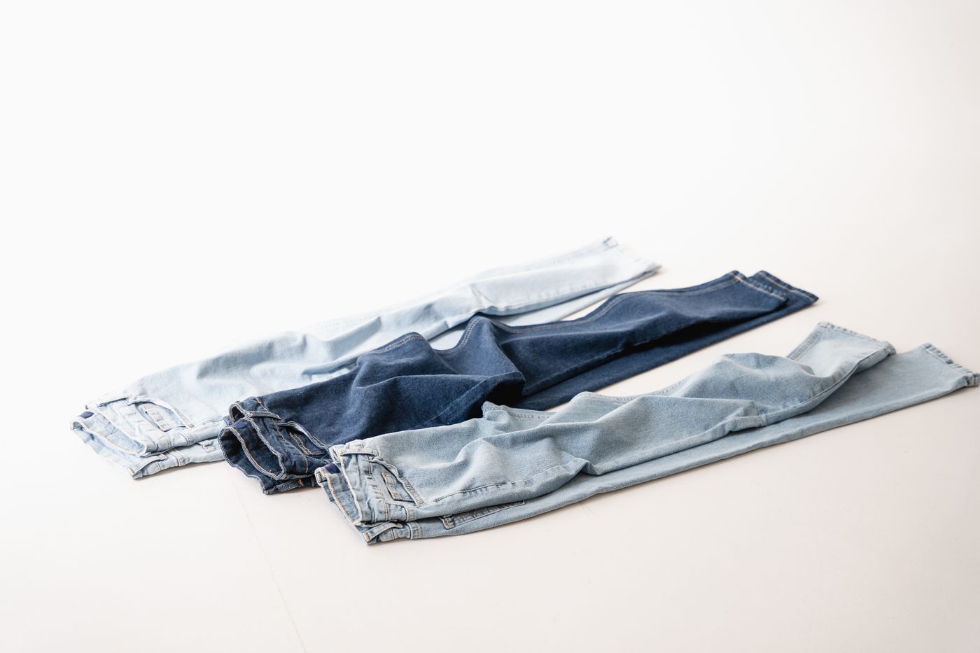 Apparel product photos with matching clean white backgrounds forming a consistent catalog grid