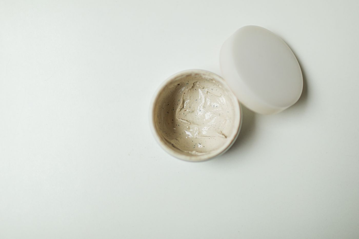 Cosmetics jar cut out on a clean white background with a soft realistic shadow