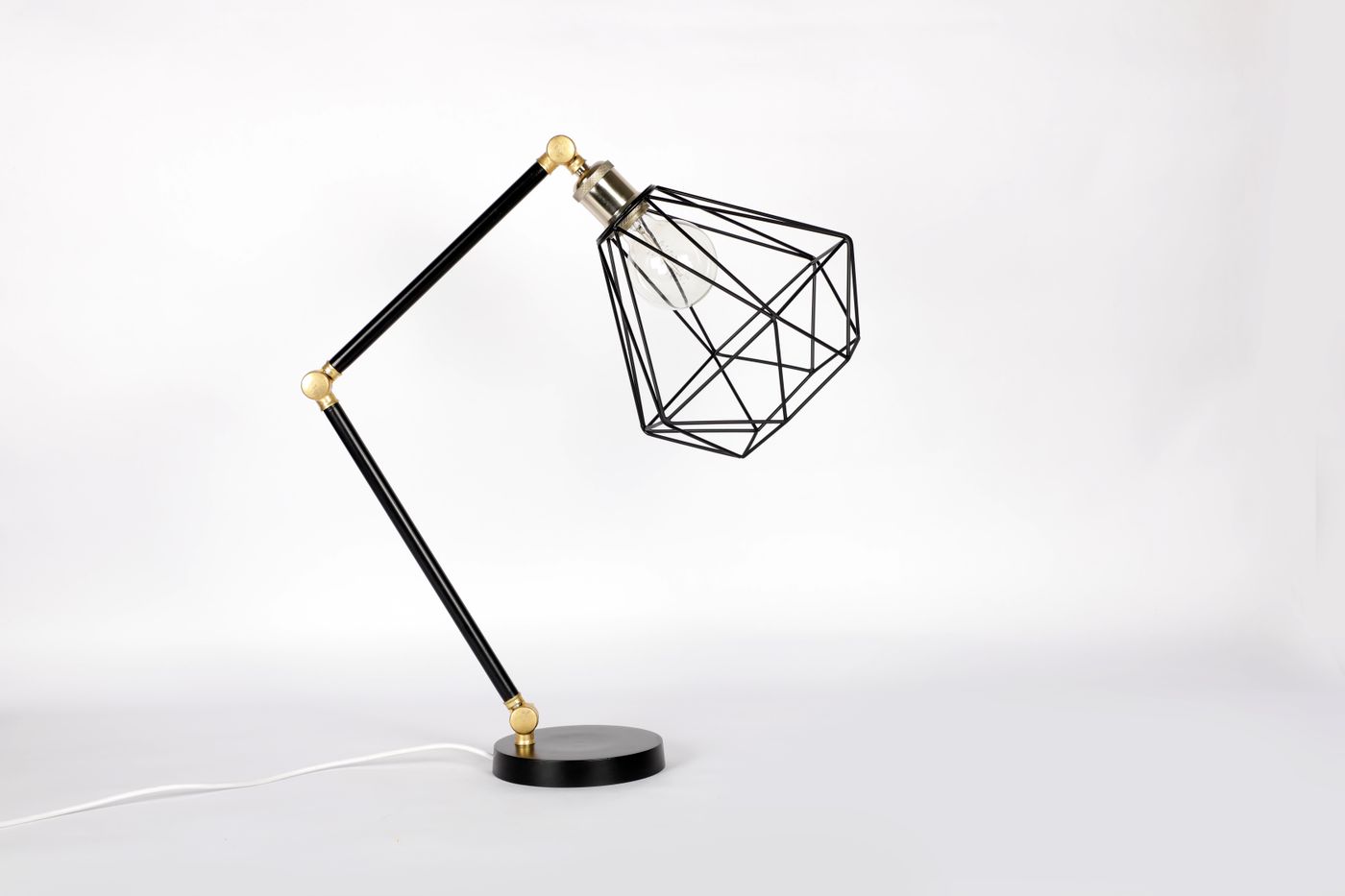 Before-and-after comparison of a used table lamp photographed on a cluttered desk, then shown on a clean white background