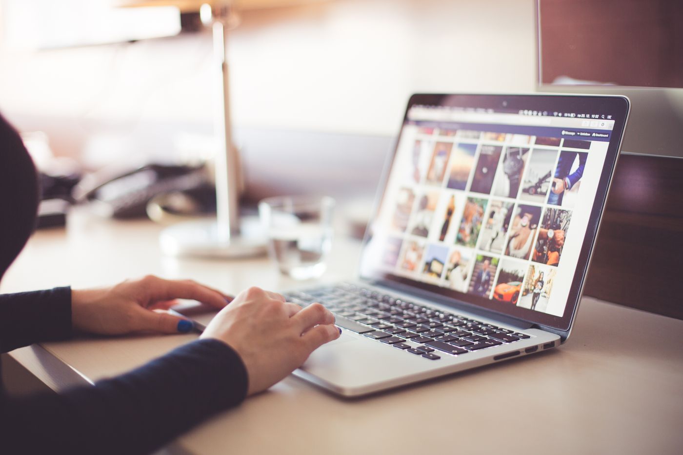 Ecommerce seller renaming product photo files on a laptop before uploading them to an online store